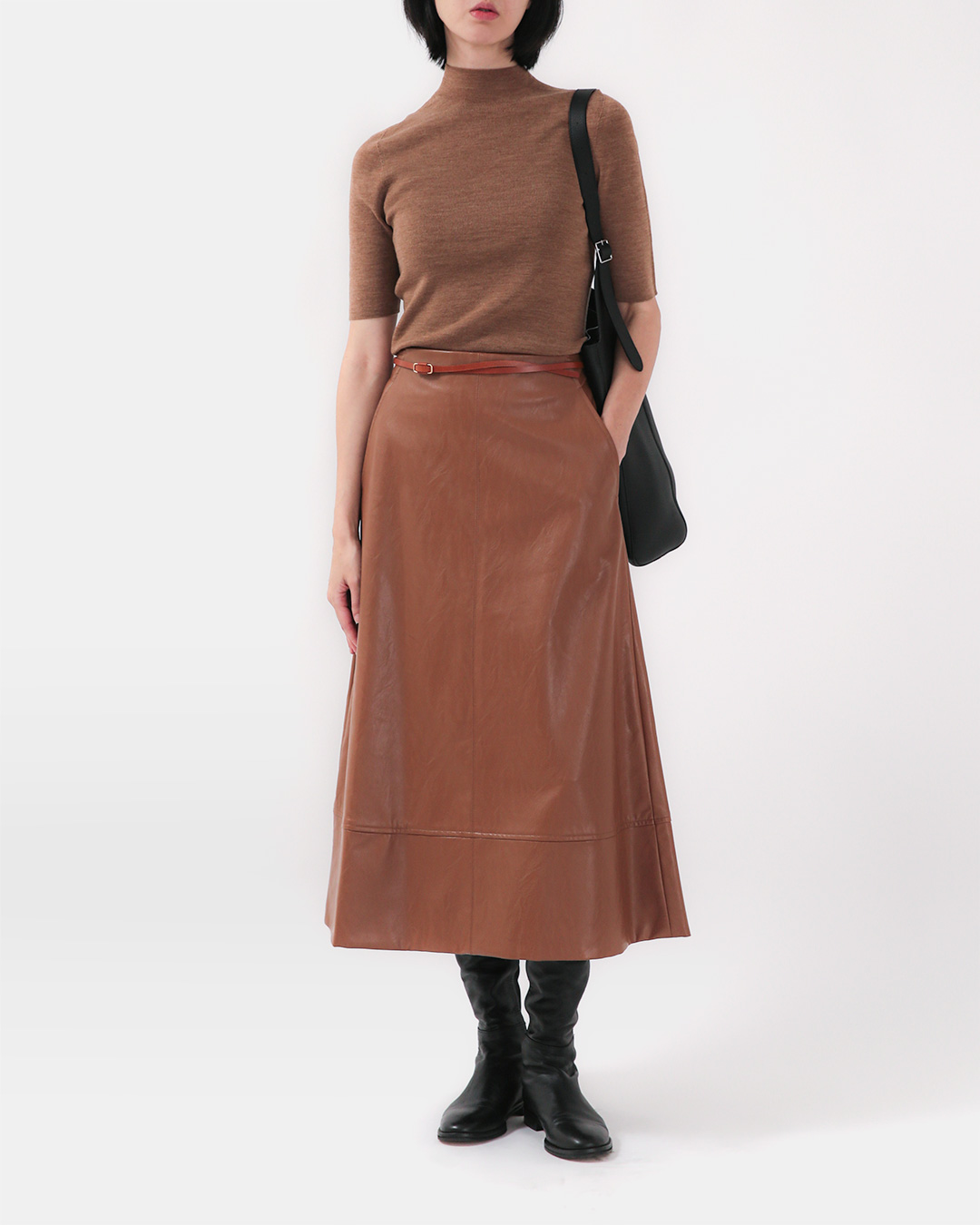 The neatness of the half-high neckline,<br> And the delicate warmth provided by 100% wool