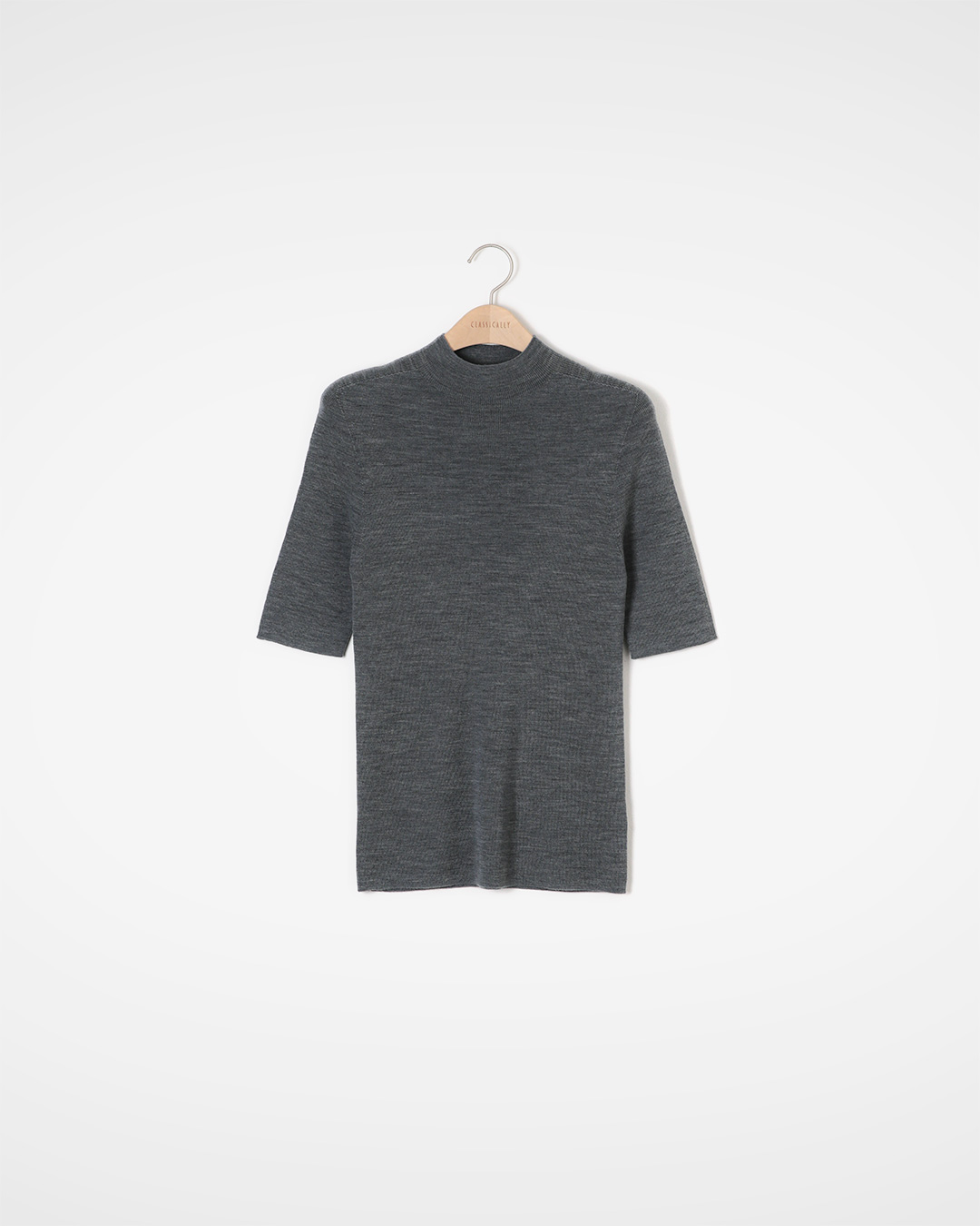 The neatness of the half-high neckline,<br> And the delicate warmth provided by 100% wool