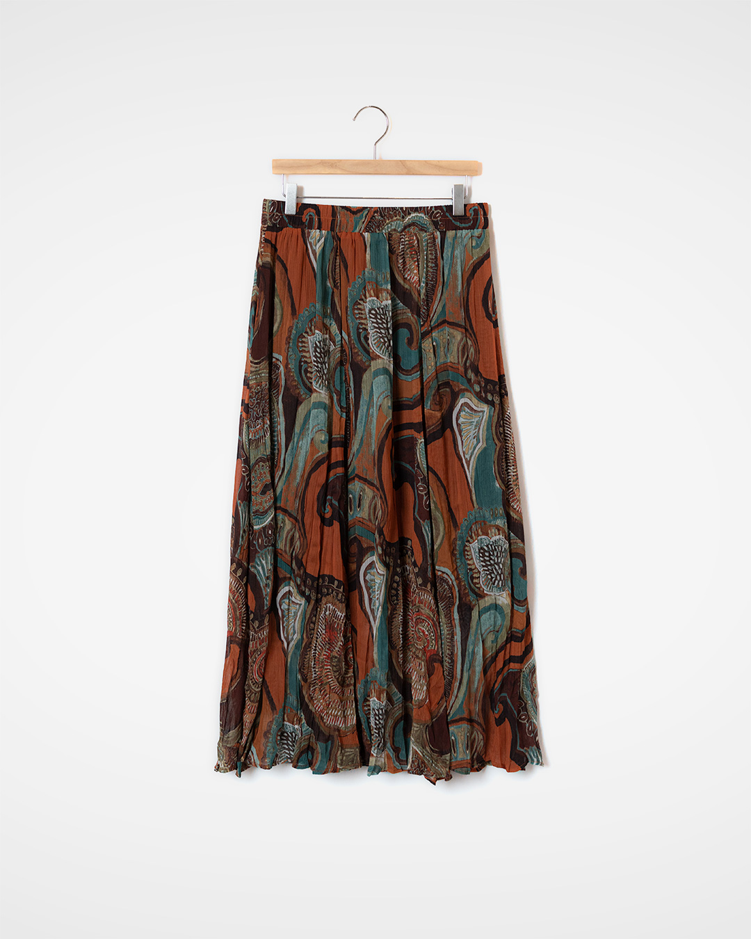 It becomes the centerpiece of the look even when paired with a simple top.<br> painterly sheer pattern skirt