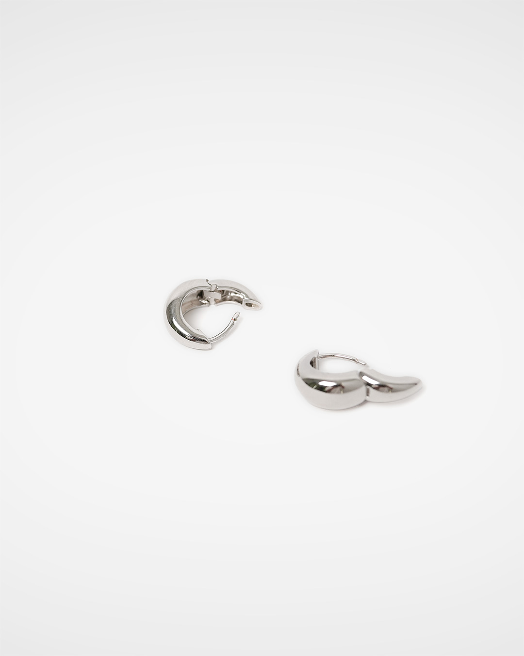 A clearly defined complexion<br> Silver Volume Hoop Earrings